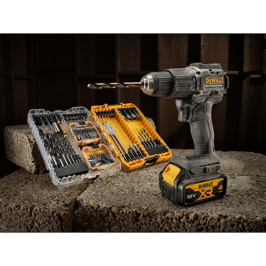 The limited edition 18V Brushless 100 year Hammer Drill Driver sitting next to open DT70784 100 piece drill drive kit