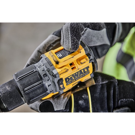 A gloved hand adjusting the speed setting on a DCD805P2T 18V XR Brushless Hammer Drill