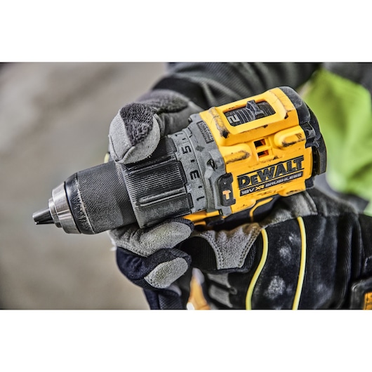 A gloved hand adjusting the speed setting on a DCD805P2T 18V XR Brushless Hammer Drill