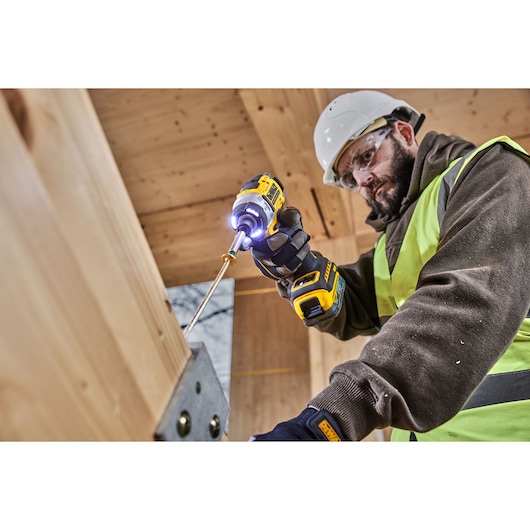 Construction worker driving a bolt using the 18V XR 4 Speed Premium Impact Driver