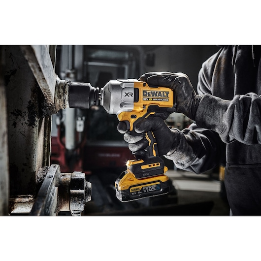 18V XR Brushless 1/2 inch High Torque Impact Wrench with socket, fastening a large bolt