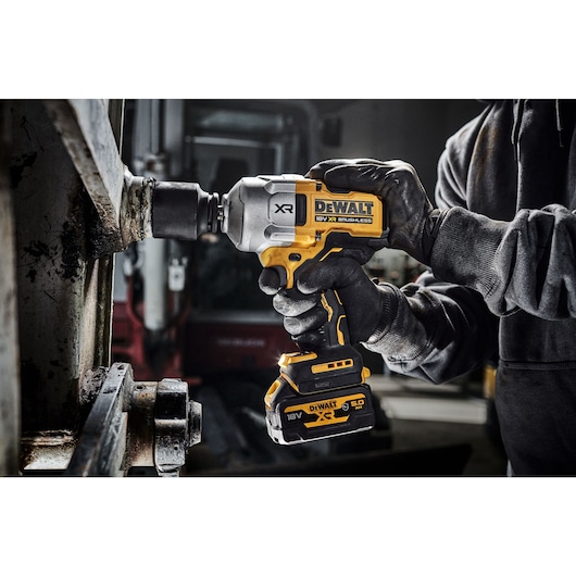 18V XR Brushless 1/2 inch High Torque Impact Wrench with socket, fastening a large bolt