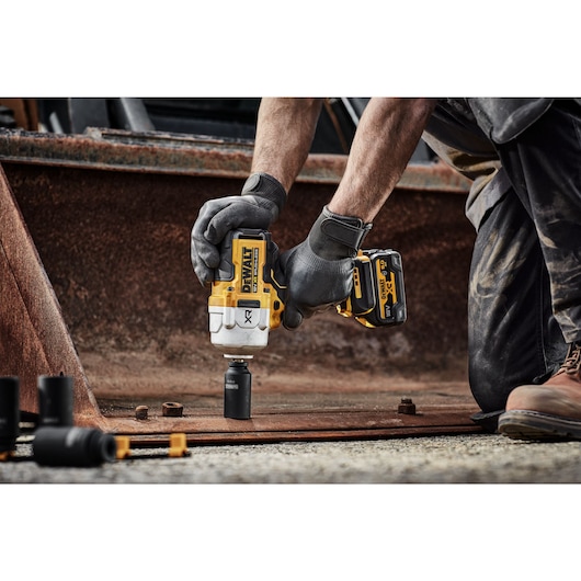 18V XR Brushless 1/2 inch High Torque Impact Wrench with socket, loosening a bolt from a metal structure 