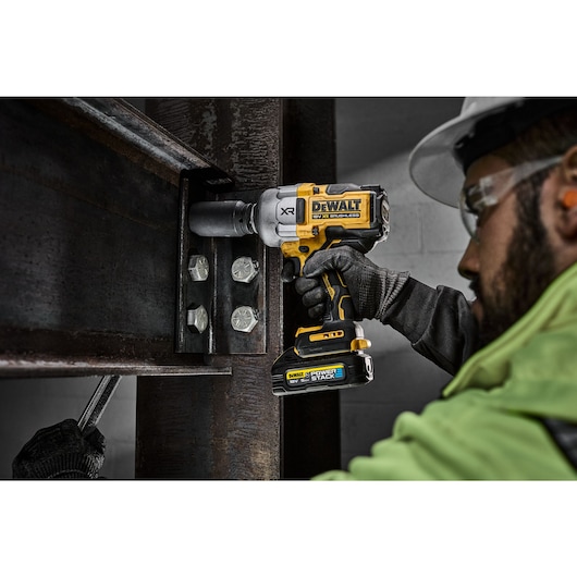 Worker using the 18V 3/4inch High Torque Impact Wrench to fasten nut in to steel beam