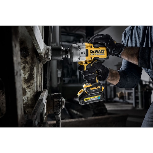 Worker using the 18V 3/4inch High Torque Impact Wrench to remove bolt from steel beam