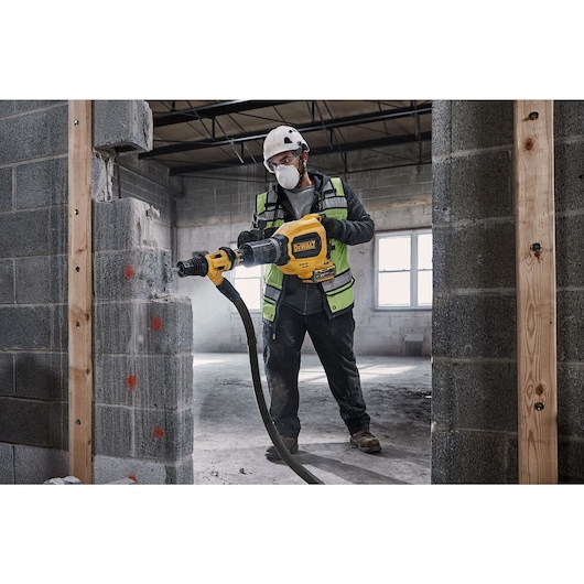 Cordless XR Flexvolt Breaker Hammer breaking a wall of breeze block