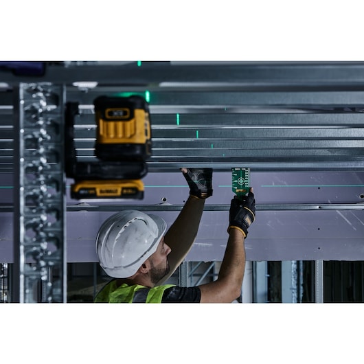 Green Cross Line Laser beaming on to a traget card on a construction site