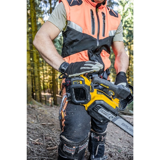 Arborist holding the DCMCST635 showing harness attachment point and D-Ring tether