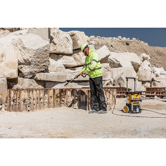 Worker cleaning on a construction site with the Dewalt 2 x 18V Cordless Pressure Washer