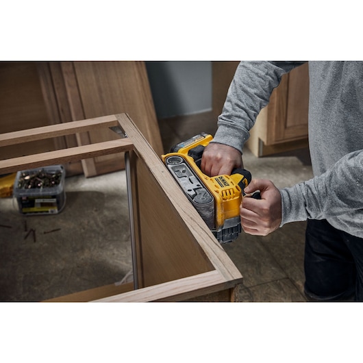 18V XR Brushless Belt Sander sanding a table