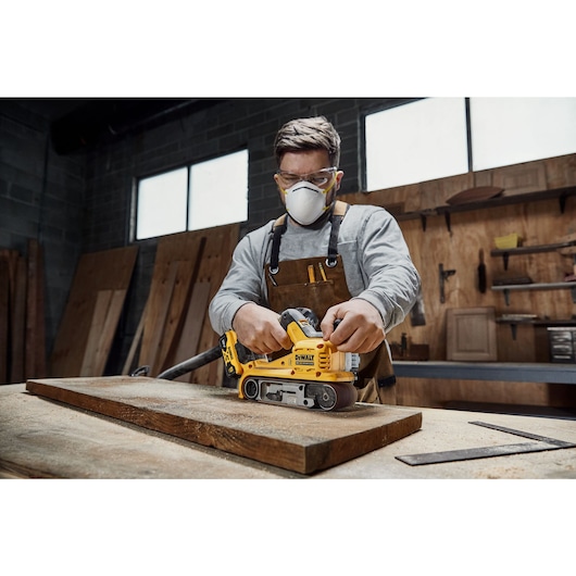 18V XR Brushless Belt Sander sanding a wooden shelf