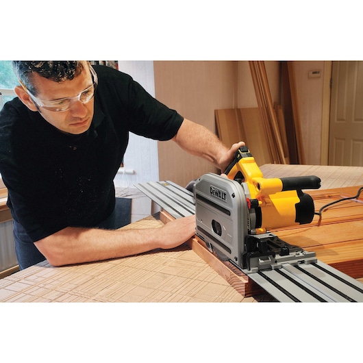 track saw kit being used by a person to cut wood.