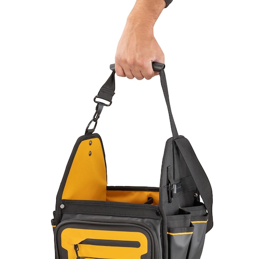 Dewalt 11" Pro Electrician Tote being carried using one of the straps"